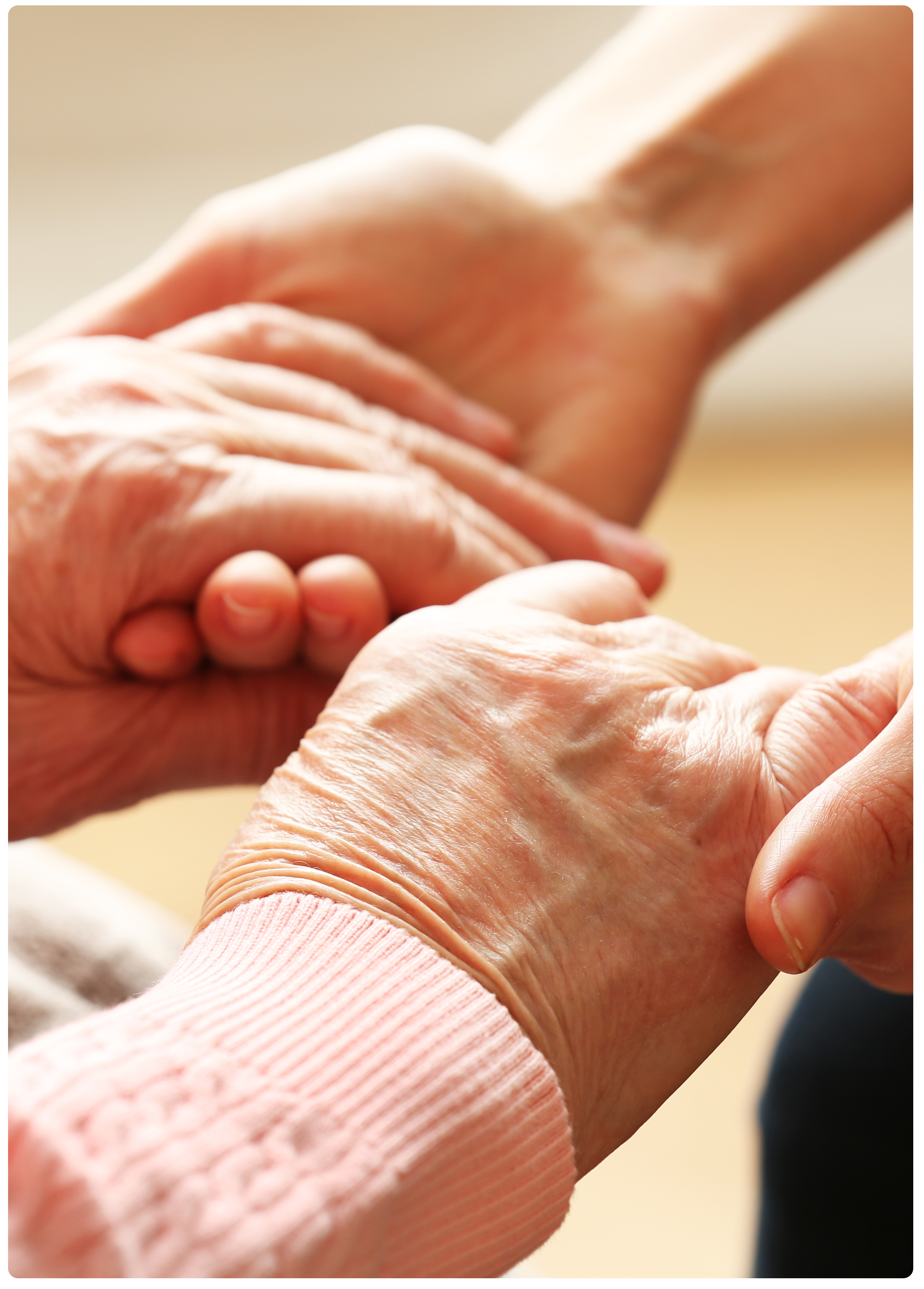 Young caring hands holding old hands